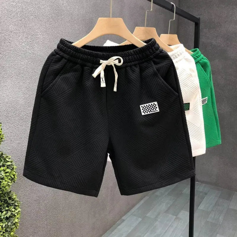 A pair of solid-colour casual sports shorts made from polyester, shown in white, suitable for beach and outdoor activities.