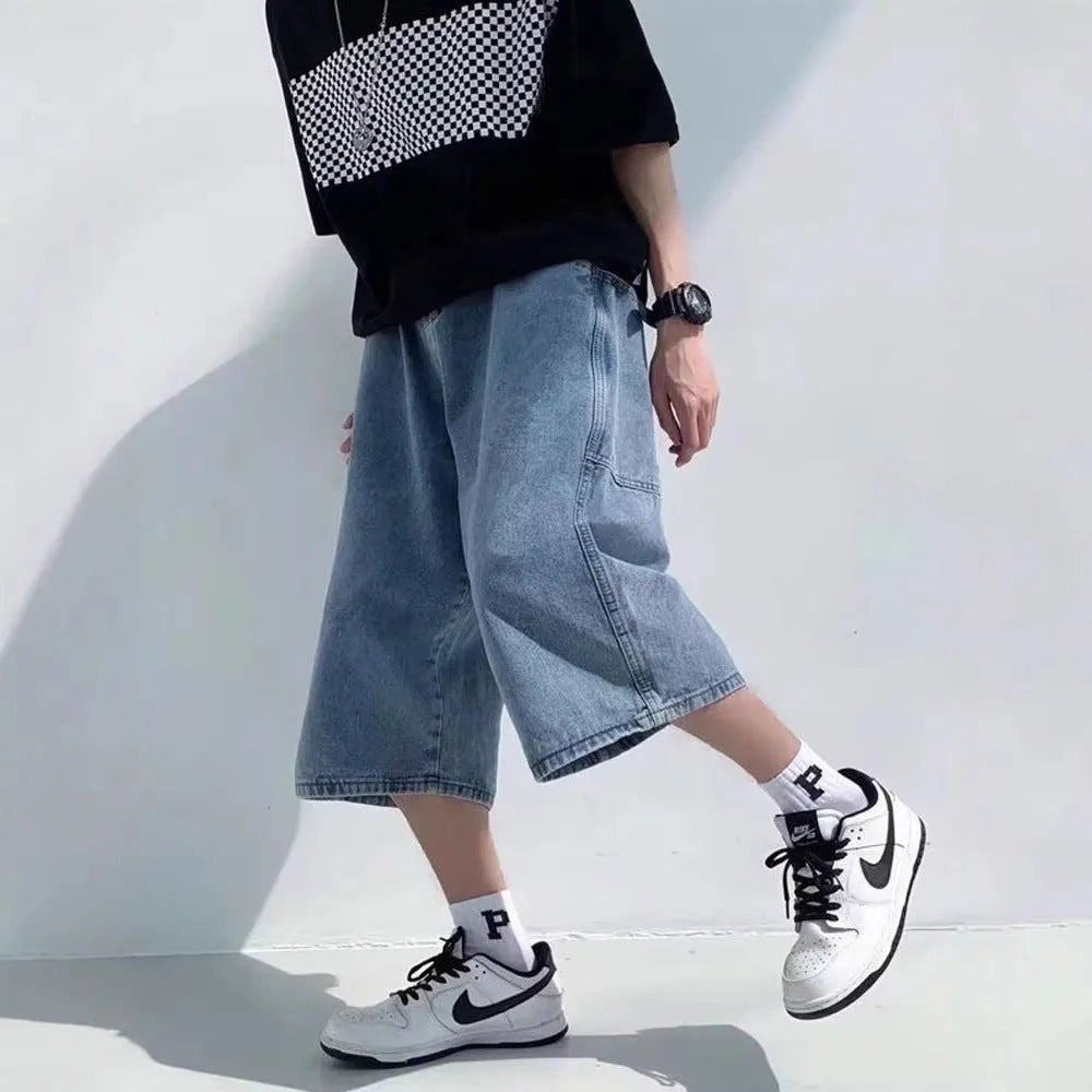 Man wearing blue washed denim pirate shorts with a cropped length and high waist.