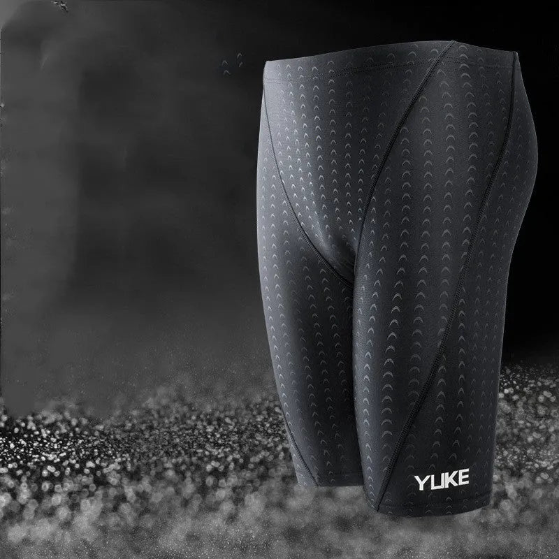 Men's black polyester swimming trunks set with anti-fog goggles, waterproof cap, ear plugs, nose clip, and carry bag.