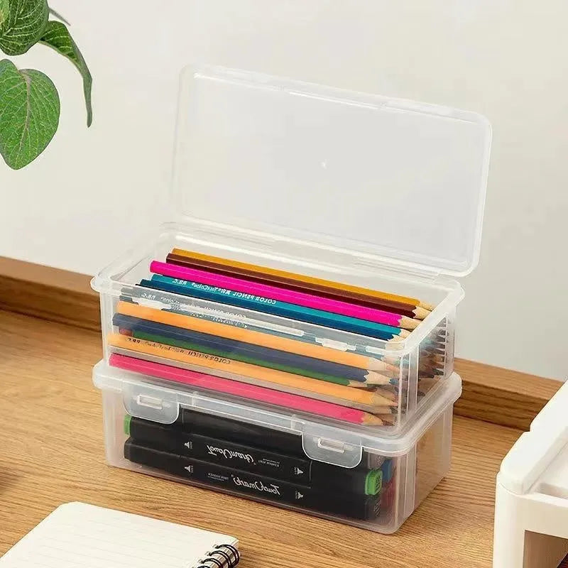 Transparent plastic pencil storage box showing interior capacity for organising drawing supplies