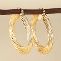 Geometric drop-shaped women's ear clip with ring design in electroplated copper.