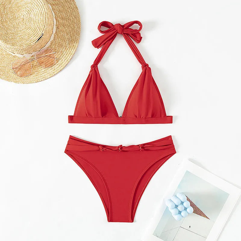 Red women's lace-up halterneck bikini with split shorts on mannequin