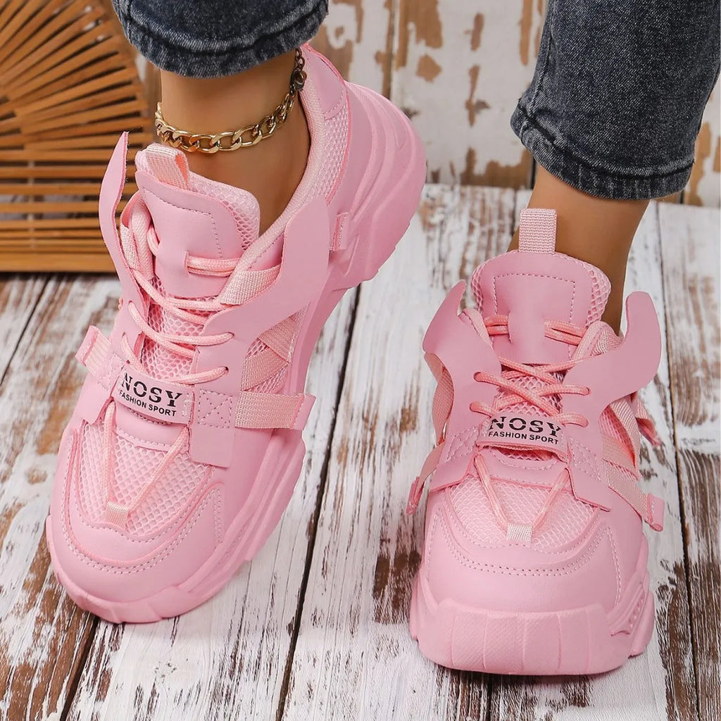 Women's purple platform mesh sports trainers with animal pattern and lace-up front on a white background.