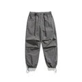 Man wearing loose straight-leg casual trousers in thin ice silk nylon fabric, shown in khaki colour.