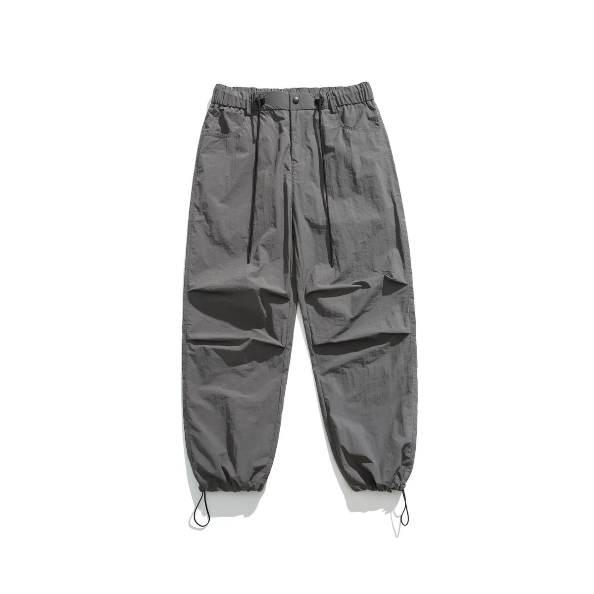 Man wearing loose straight-leg casual trousers in thin ice silk nylon fabric, shown in khaki colour.