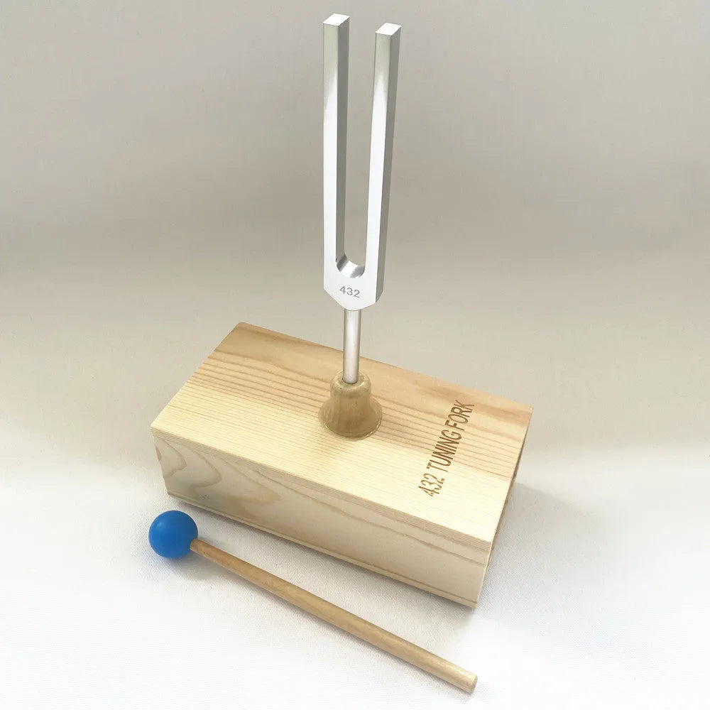 Aluminium alloy 432 Hz tuning fork with a matching speaker unit on a kraft paper box.