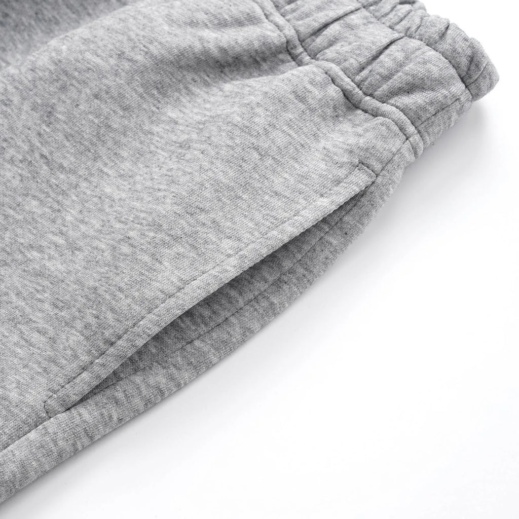 Men's straight-leg casual cotton trousers in solid black colour showing loose fit design