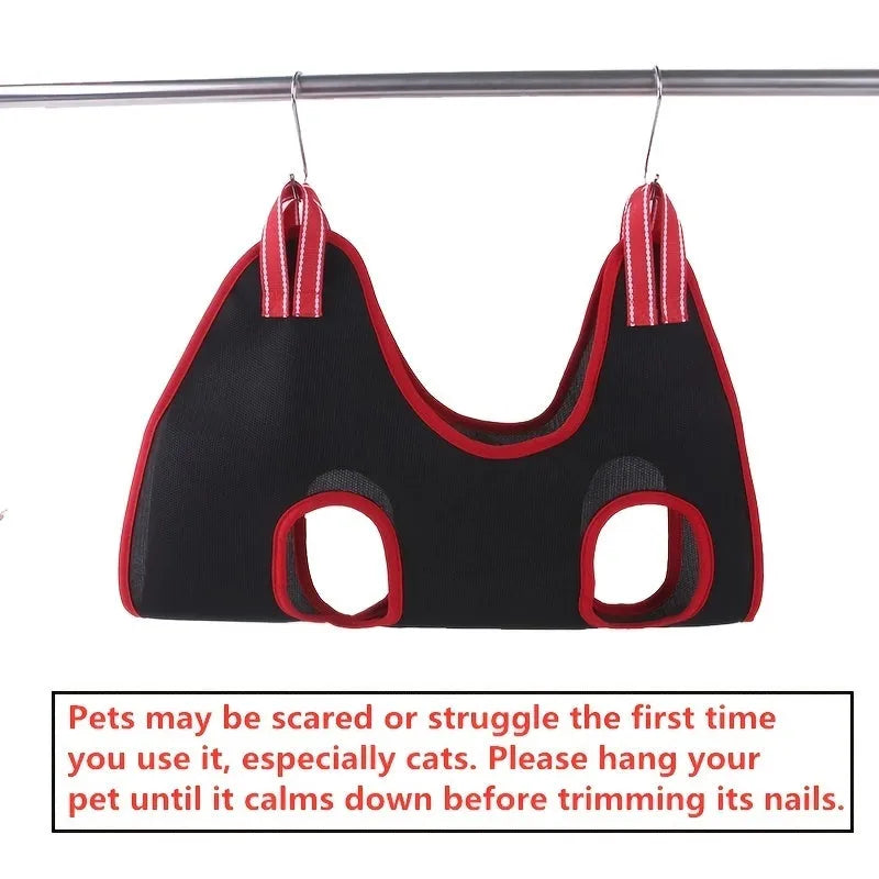 A suspended nylon mesh pet grooming hammock with a top zipper, hanging from its adjustable strap.