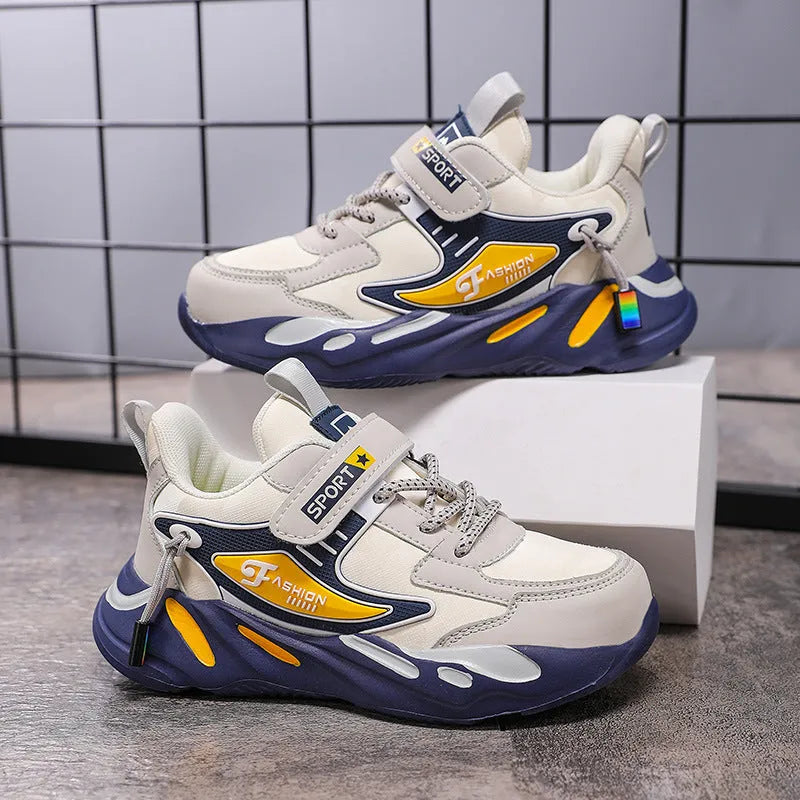 Boys' blue and black platform sports running shoes with Velcro straps on a hard ground surface.