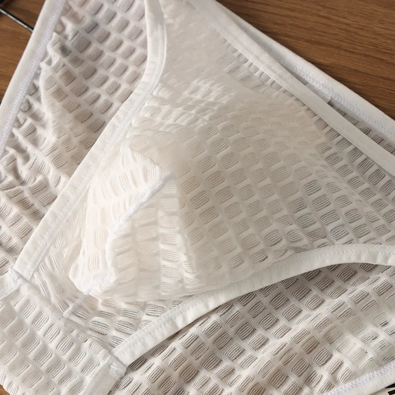Men's low waist transparent lace underwear in black on a mannequin