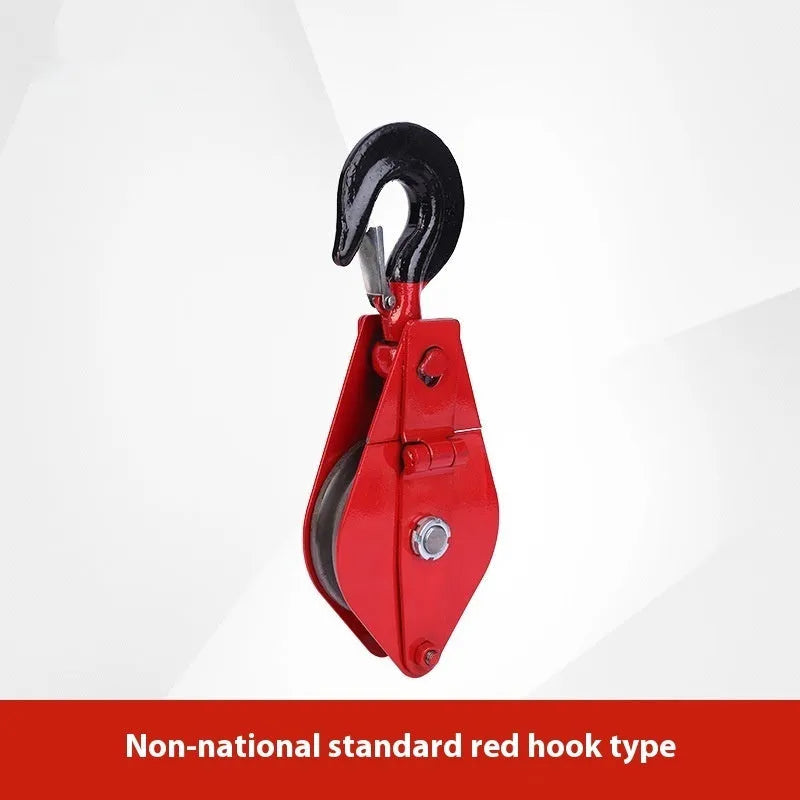 A small red industrial lifting pulley with a forged steel hook and safety latch.