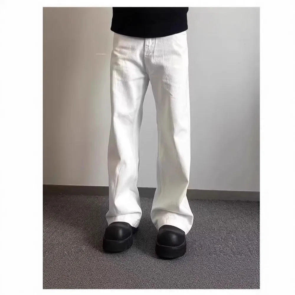 Men's white straight-leg denim jeans on a neutral background, showing mid waist and loose fit.