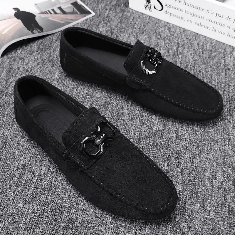 Men's black and grey suede and leather casual sneakers with rubber sole on a plain background.
