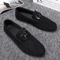 Men's black and grey suede and leather casual sneakers with rubber sole on a plain background.