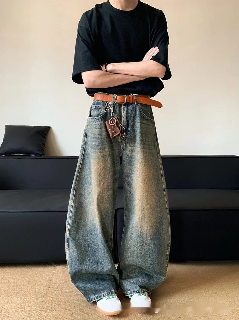Men's retro blue distressed denim wide-leg trousers showing distressed detailing and wide-leg silhouette