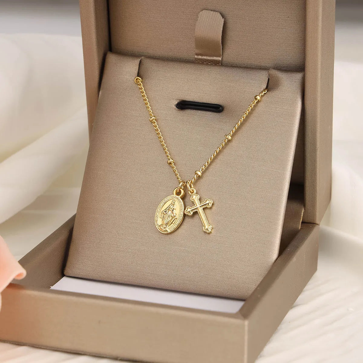Golden Virgin Mary necklace with geometric cross pendant on copper chain