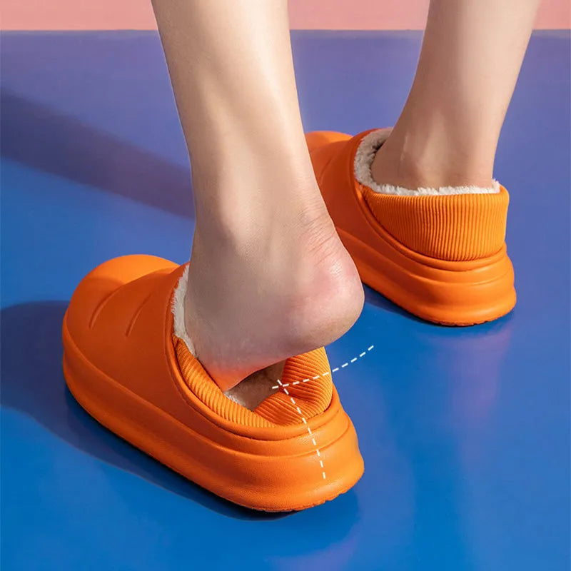 A pair of waterproof EVA couple slippers with a plush lining, shown in a choice of colours like green, pink, or grey.