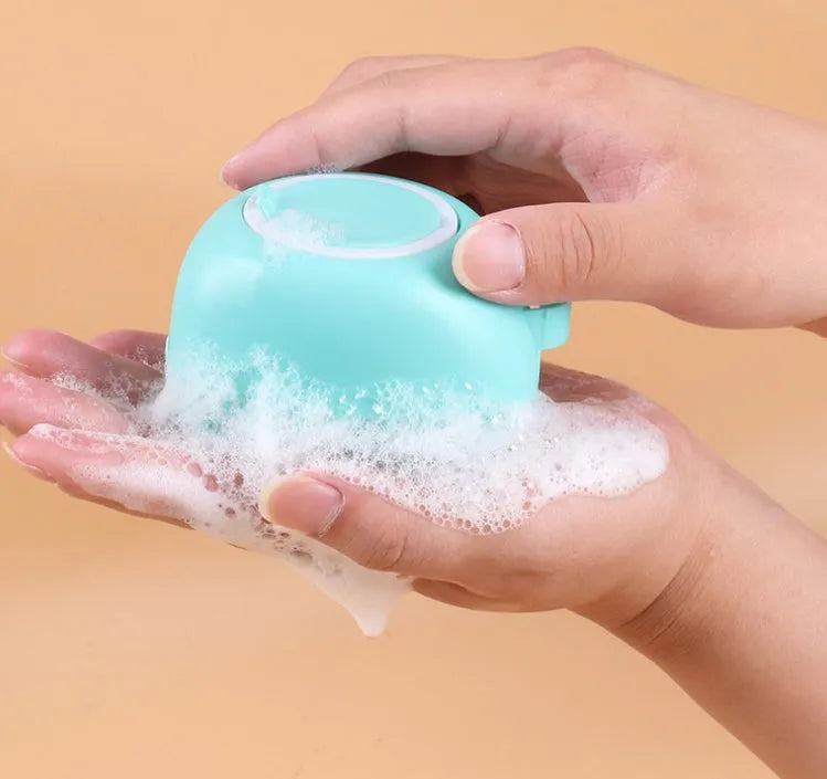 Silicone dog bath brush with ergonomic handle in blue, pink, or yellow colour