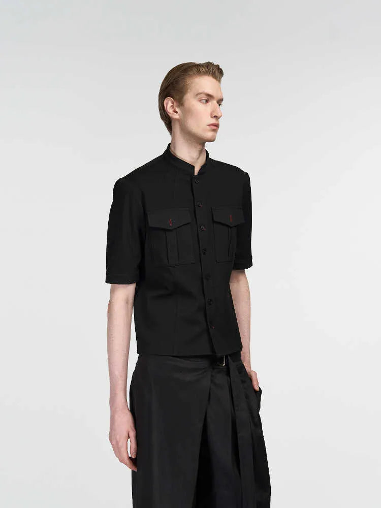 Black handmade Red Eye half sleeve hunting shirt with a shirt collar on a hanger.