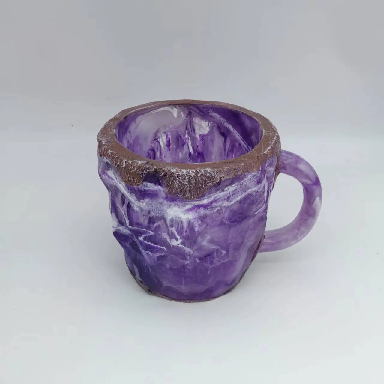 Resin mineral crystal coffee mug with handle in purple colour, showing 3D texture.