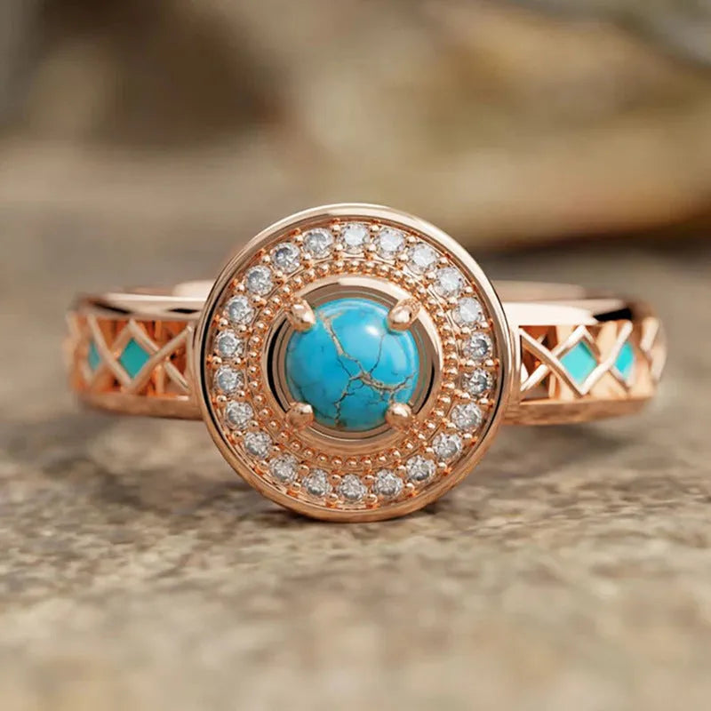 Women's rose gold copper ring with turquoise stone and geometric zircon inlay design.