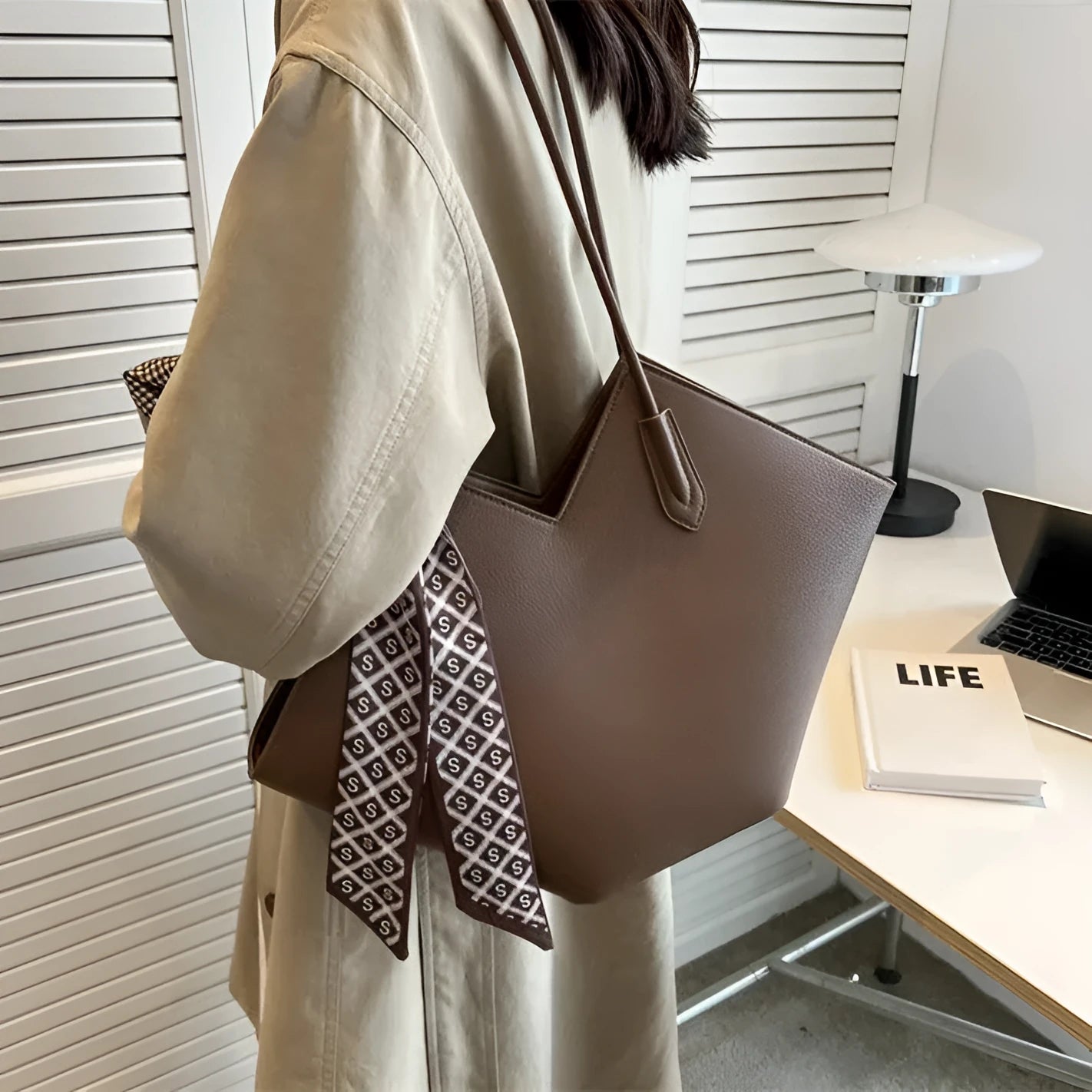 Women's black PU shoulder bag showing sandwich pocket compartments and 43cm width