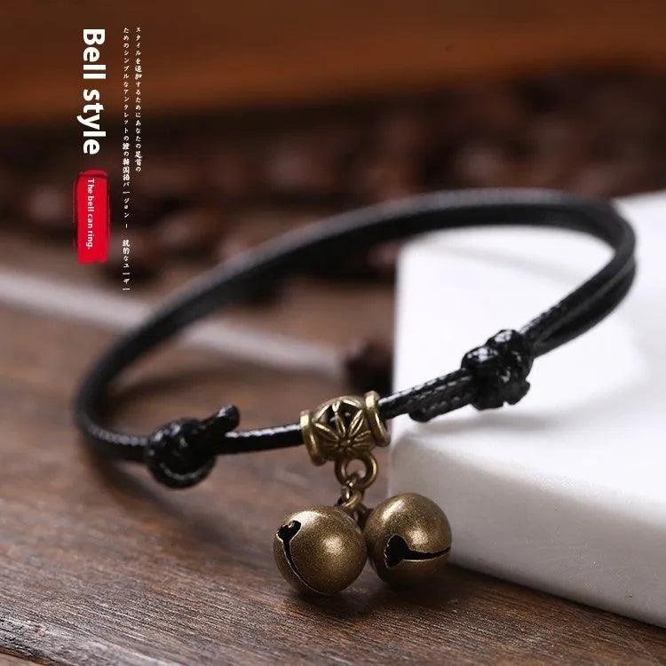 Nylon dog collar with brass bell shown in black rope colour, adjustable size 8 to 17 cm