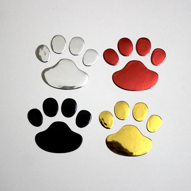 Pair of hand-shaped brush stroke car stickers with dog footprint details on a vehicle bumper.