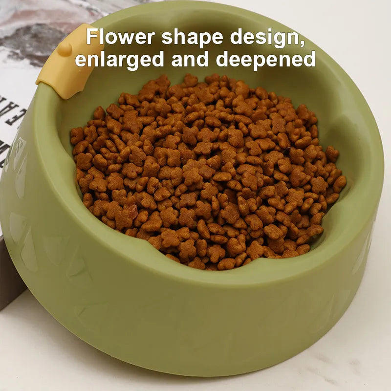 Green plastic double pet bowl with flower-shaped base for cat or small dog food and water.