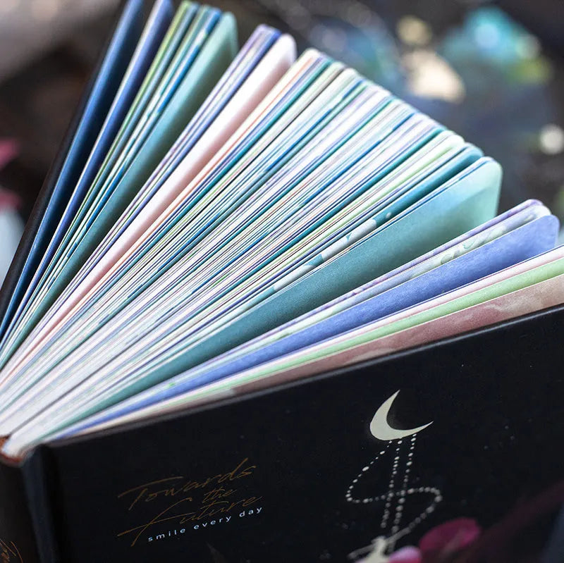 A5 notebook with luminous cover open to show colour illustrated pages, in Purple colour option.