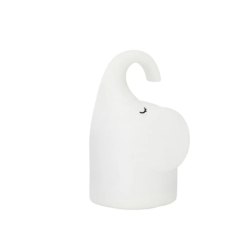 Elephant shaped silicone night light with warm 3000k LED glow on a bedside table