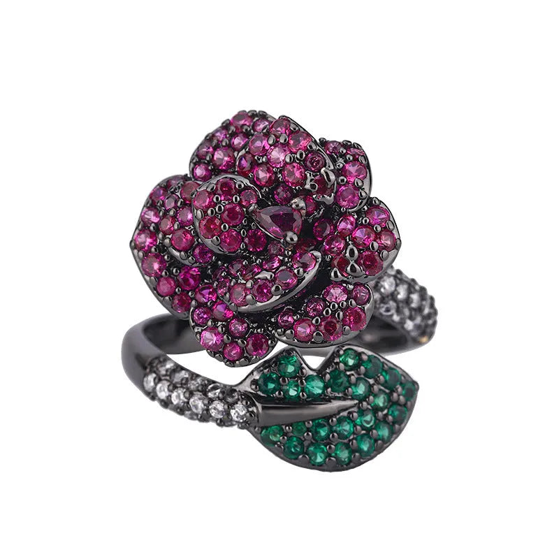Gold-plated copper women's ring with geometric flower design and simulated red corundum in black gold colour.