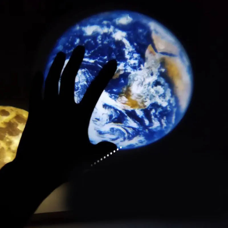 Earth and Moon star projection lamp with adjustable bracket on bedside table