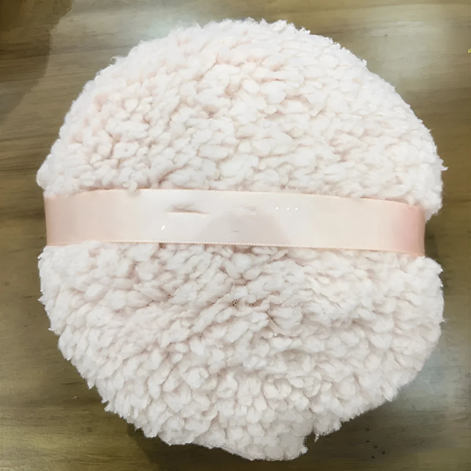 Oversized rectangular plush powder puff in pink, white, or skin colour on a plain background.