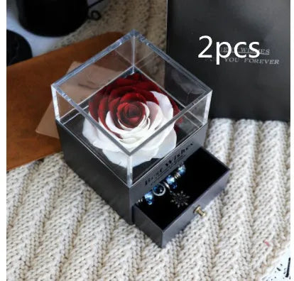 Glass eternal flower jewellery box with preserved roses and carnations inside measuring 8.5cm square