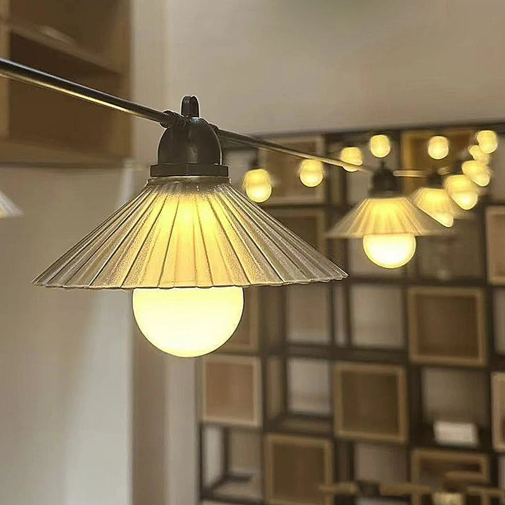 Outdoor LED string lights with flower-shaped bulbs hanging in a garden setting.