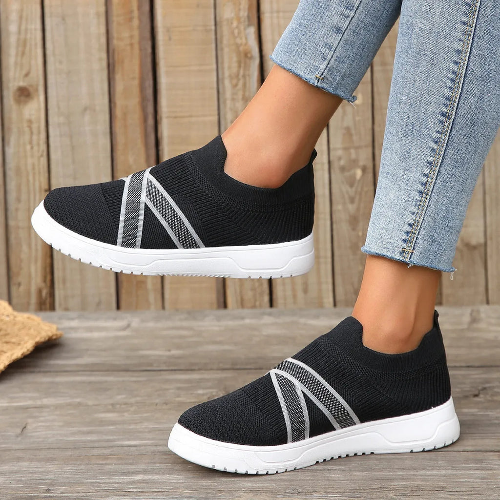 Black women's flyknit mesh casual shoes with flat rubber sole and tassel detail