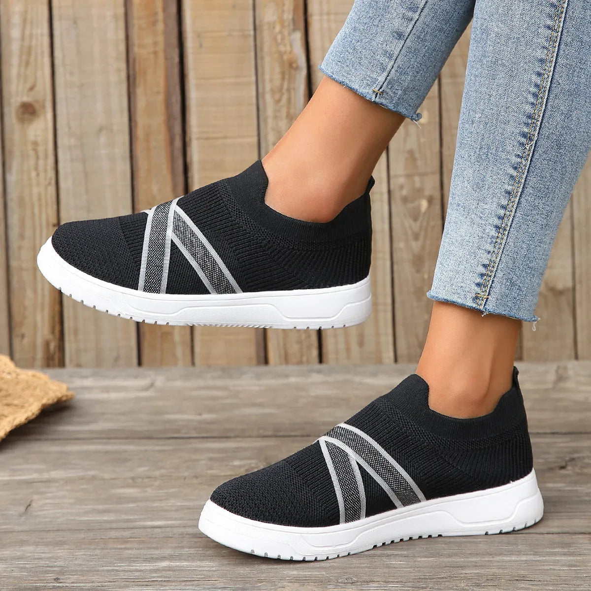 Black women's flyknit mesh casual shoes with flat rubber sole and tassel detail