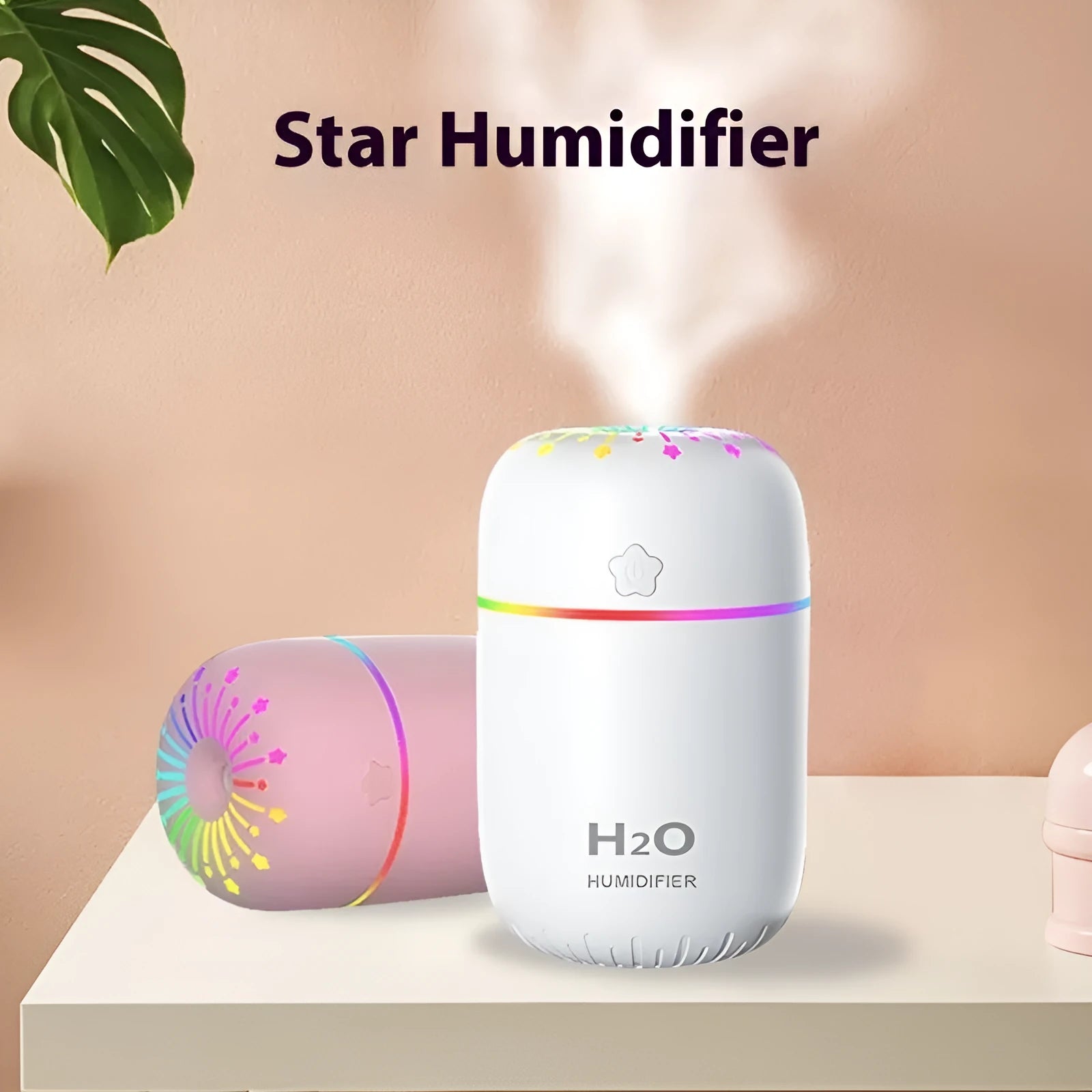 Small white USB-powered mini humidifier with water tank on a desk next to a laptop.