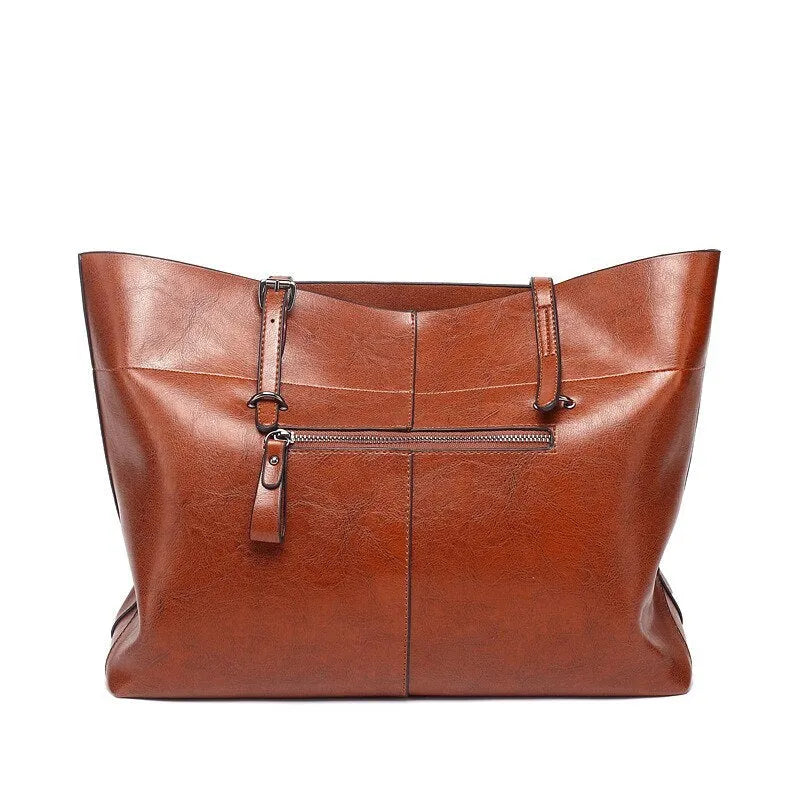 Brown waxed cowhide leather ladies crossbody handbag shown open, revealing internal organiser pockets.