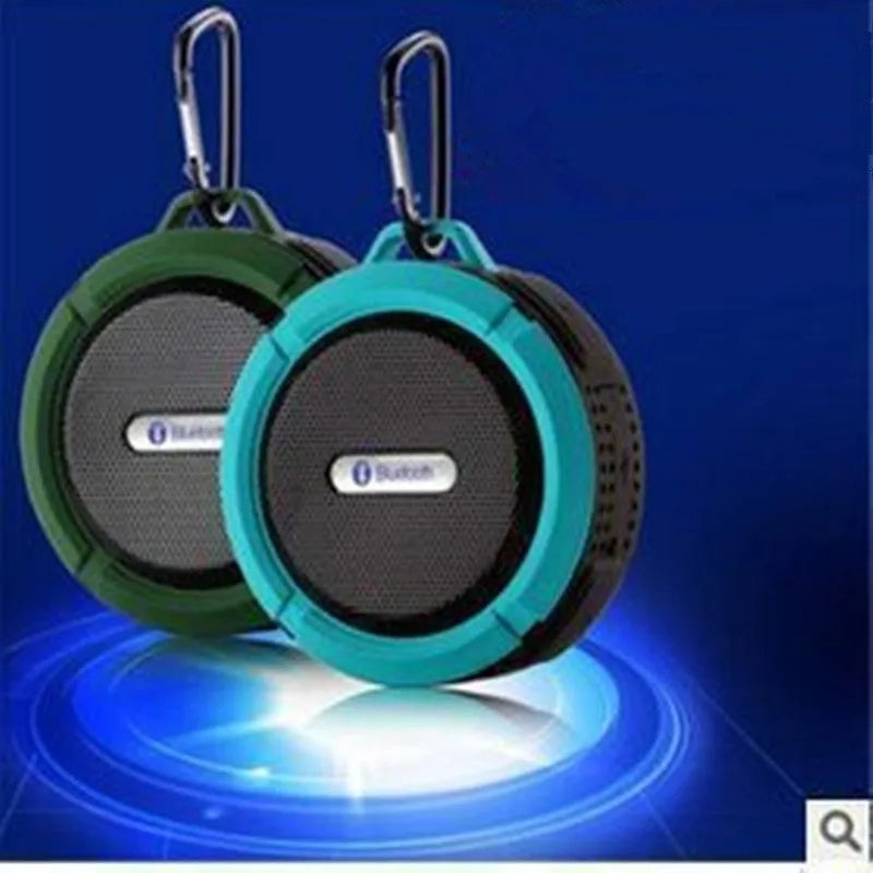 Portable waterproof Bluetooth speaker in multiple colours with a built-in carabiner clip for bags.