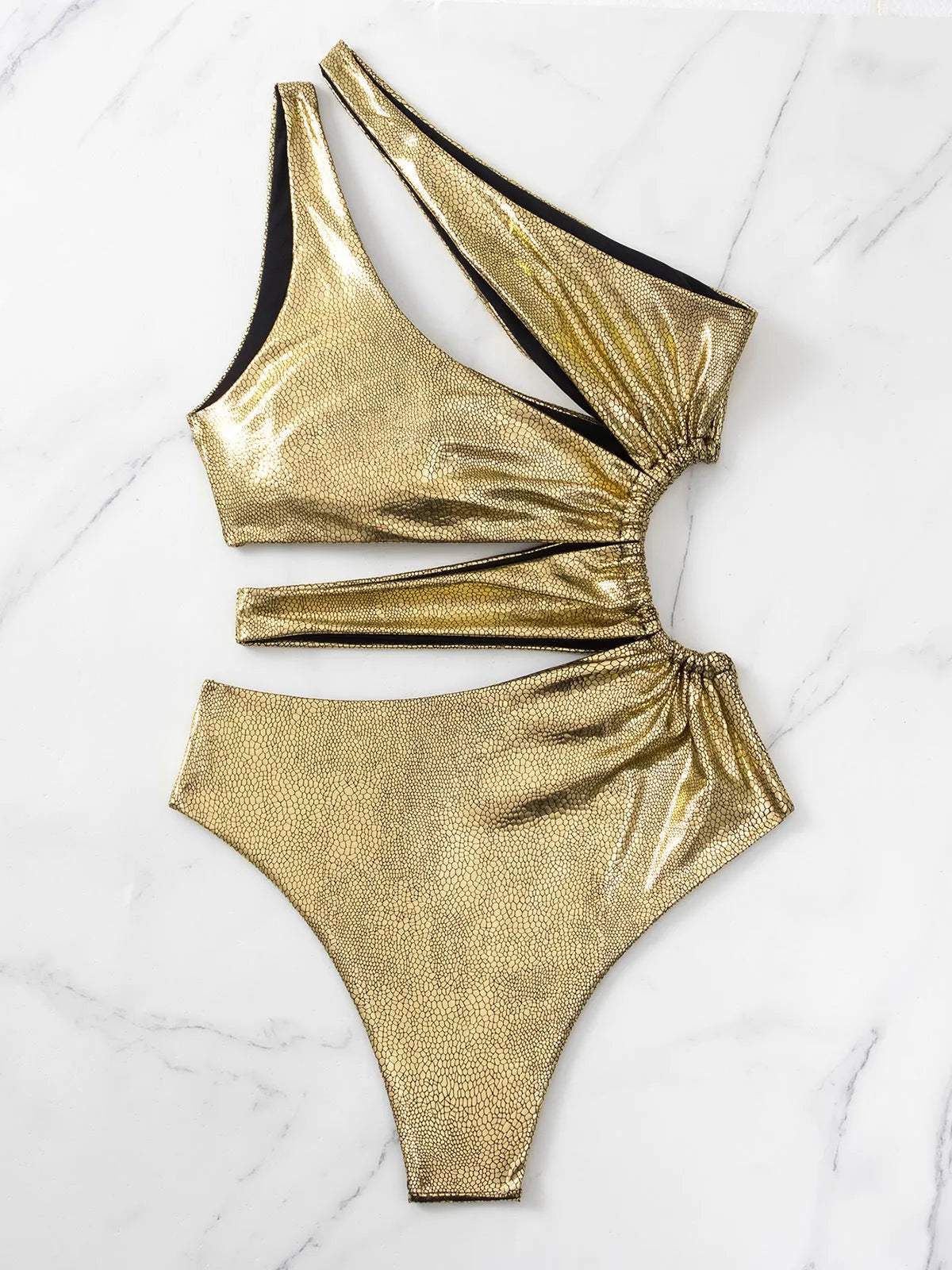 Gold women's one-piece swimsuit with backless design and sleeveless construction