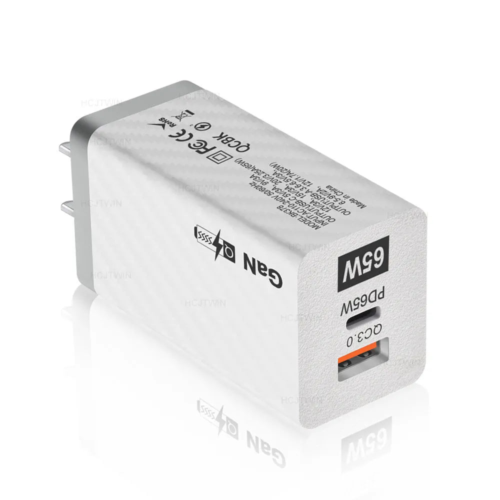 White GaN 65W universal laptop charger with USB PD port showing compact dimensions