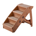 Foldable grey plastic pet stairs for small dogs and cats placed next to a sofa, showing non-slip mats on steps.