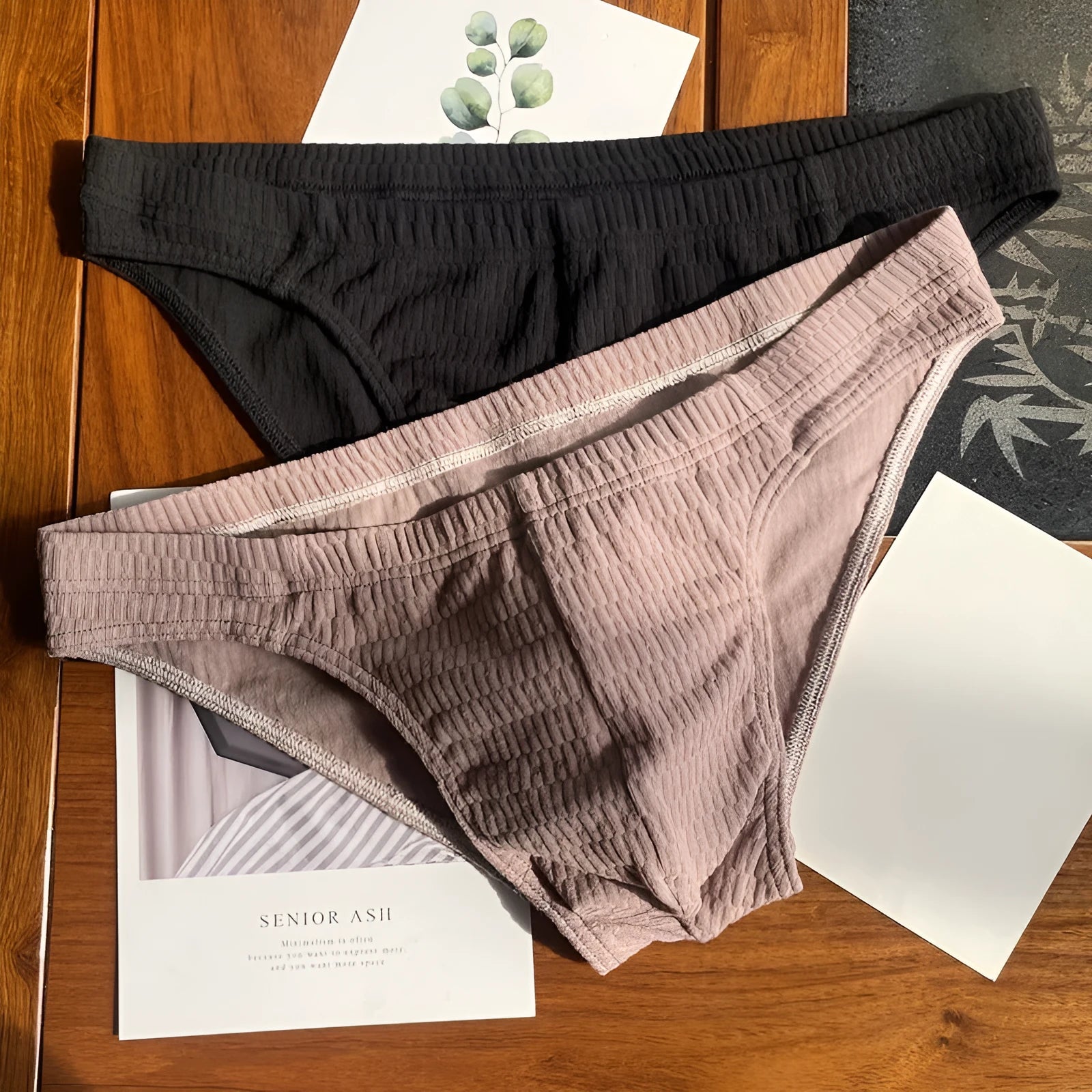 Men's solid colour cotton triangle briefs with a mid waist design on a white background.