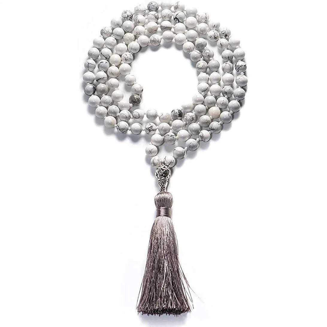 Geometric agate pendant necklace with colourful stone pattern and tassel detail on model