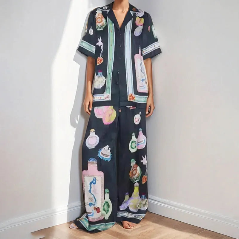 Women's black casual matching set with cartoon animation print, featuring a cardigan sleeve top and trousers