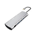 Grey aluminium USB-C docking station with HDMI, VGA, and USB 3.0 ports.
