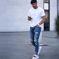 Men's deep blue cotton jeans on a hanger, showing the classic five-pocket design.