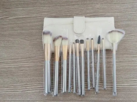 Persian make-up brush set with rice white bristles and champagne colour metal handles, showing 12 brushes.